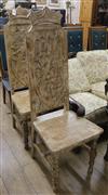 A pair of painted high back chairs, the panels carved with eagles and lions                                                            