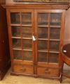 A Continental glazed teak two drawer bookcase W.102cm                                                                                  