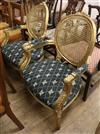 A pair of Louis XV style carved giltwood caned back fauteuils                                                                          