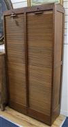 An oak double tambour shutter filing cabinet W.92cm                                                                                    