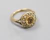 A 9ct, citrine and seed pearl set circular cluster ring                                                                                                                                                                     