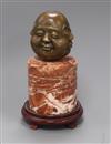 An Eastern bronze four mask Buddhistic head, on marble socle height 28cm. incl. wood stand                                             