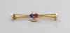 An Edwardian yellow metal, ruby, sapphire and diamond set clover bar brooch                                                                                                                                                 