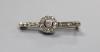 An early 20th century white metal (stamped 9ct) and diamond target cluster set bar brooch                                                                                                                                   