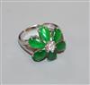 A modern 18k white metal, jadeite and diamond set flowerhead cluster ring, size P.                                                     