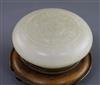 A Chinese white jade circular seal paste box, 18th/19th century, D. 6.5cm, wood stand                                                  