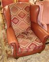 A leather and tapestry upholstered armchair                                                                                            