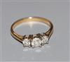 A modern 18ct gold and three stone diamond ring, with IGI report stating the total diamond weight to be 0.75cts, size Q.               