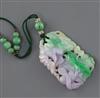 A Chinese jadeite pendant, first half 20th century, retailed by Liberty & Co., London, in a 'Liberty London & Paris' fabric box        