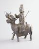 A Chinese white metal model of a boy riding a qilin , early 20th century, 12.5cm long                                                                                                                                       