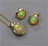 A modern 14ct gold and opal pendant necklace and a pair of matching ear studs.                                                         