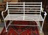 A white painted wrought iron garden bench, length 122cm, depth 48cm, height 90cm                                                                                                                                            