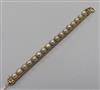 A yellow metal and split pearl set cagework line bracelet. 17.5cm.                                                                     