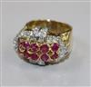 A yellow metal, ruby and diamond cluster dress ring, size O.                                                                           