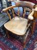 A Victorian elm and beech smokers bow elbow chair, together with a later mahogany desk chair.                                                                                                                               