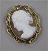 A yellow metal mounted oval cameo brooch, carved with the bust of a lady to dexter, 67mm.                                              