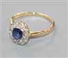 A mid 20th century 18ct gold, sapphire and diamond oval cluster ring, size Q.                                                          