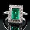 An Art Deco style 18ct white gold, emerald and diamond tablet cluster ring, size O.                                                    