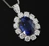 A platinum-set sapphire and diamond oval cluster pendant on 18ct white gold chain, pendant 28mm overall.                               