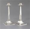 A pair of Edwardian Arts and Crafts silver candlesticks by James Dixon & Sons, 22cm.                                                   