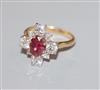 An 18ct yellow metal, single stone ruby and graduated eight stone diamond cluster ring, size M.                                        