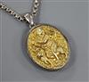 An Indian white and yellow metal oval locket embossed with a deity, on a white metal chain, locket 5cm.                                