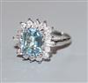 A modern 18ct white metal, aquamarine, baguette and round cut diamond set cluster ring, size K/L.                                      