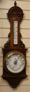 An oak aneroid barometer                                                                                                               