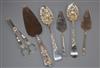 Two George III silver berry spoons, a pair of silver grape shears, a pair of small servers and a silver handled cake server.           