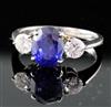 An 18ct white gold, sapphire and diamond three-stone ring, size N.                                                                     