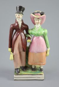 A Staffordshire pearlware group of a Dandy and Dandizette, c.1820, 21cm high                                                           