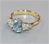 A modern 18ct gold, aquamarine and diamond set dress ring, size N.                                                                     