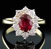 An 18ct yellow gold and platinum, ruby and diamond oval cluster ring, size O/P.                                                        