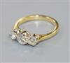 A modern 18ct gold and three stone diamond ring, size L.                                                                               