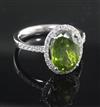 A modern 18ct white gold, green tourmaline and diamond oval cluster ring, size O.                                                      