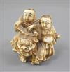 A Japanese ivory okimono of two boys with a Buddhist lion, Meiji period, height 5cm                                                    