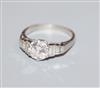 A white metal and single stone diamond ring, with graduated baguette cut diamond set shoulders, size K.                                