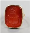 A yellow metal and carved carnelian intaglio ring, size F.                                                                             