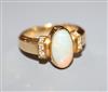 A modern 750 yellow metal, white opal and diamond set dress ring, size L/M.                                                            