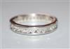 A modern platinum and channel set round brilliant cut diamond set full eternity ring, size M/N.                                        