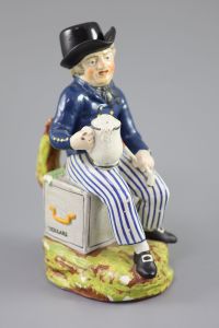An American Pearlware sailor Toby jug with hat, 'Success to our Wooden Walls, c.1820, 27cm high                                        