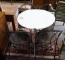 A circular metal garden table, diameter 70cm, height 76cm and four chairs                                                                                                                                                   