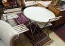 A circular metal folding garden table, diameter 96cm, height 71cm together with four slatted metal folding chairs                                                                                                           