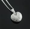 A modern 18ct white gold and pave set diamond heart shaped pendant, on an 18ct white gold chain, pendant 12mm.                         