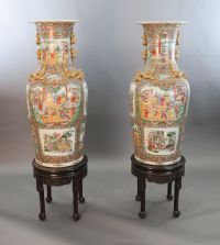 A pair of massive Chinese Canton style famille rose vases, 20th century and a pair of Chinese hongmu and marble stands, late 19th centu