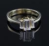 A modern 750 gold and graduated baguette cut diamond three stone ring, size Q/R.                                                       