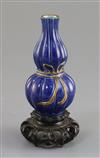 A small Chinese blue glazed double gourd vase, 18th/19th century, H. 10.7cm, good carved wood stand,                                   