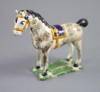 A North Country pearlware figure of a dapple horse with blue saddle, c.1800-20 14.5cm high                                             