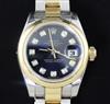 A lady's stainless steel and yellow gold Rolex Oyster Perpetual Datejust wristwatch with dark bLue dial and diamond-set numerals, boxed