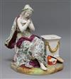 A Meissen-style figure seated beside a pedestal height 29cm                                                                            